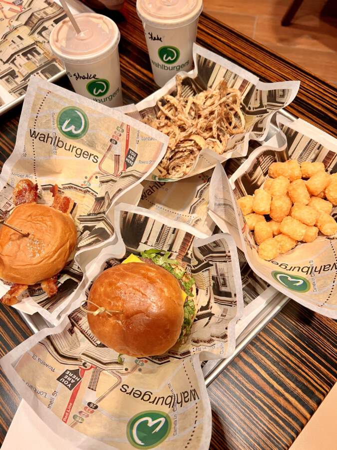 Wahlburgers cheese burger and BBQ bacon burger with tater tots and onion rings at the Dayton, Ohio location 